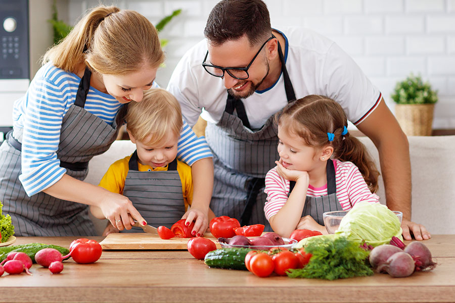 Personal Insurance - Happy Family With Children Preparing Vegetable Salad