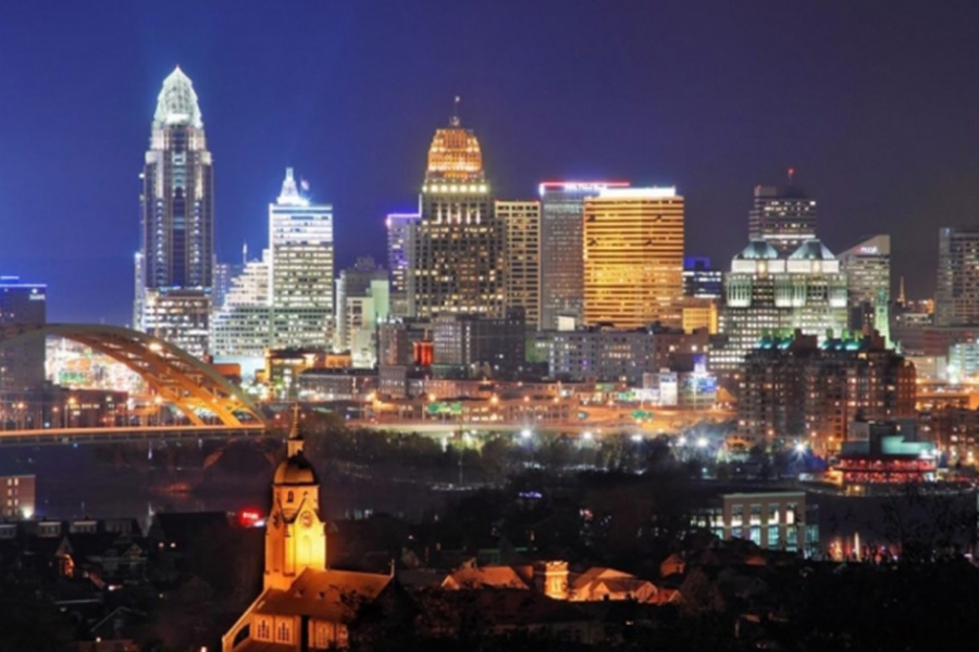Contact - Nighttime View of Cincinnati, OH Skyline With Buildings Shining Their Lights